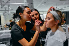 Two SRC students applying make up to a beauty salon client