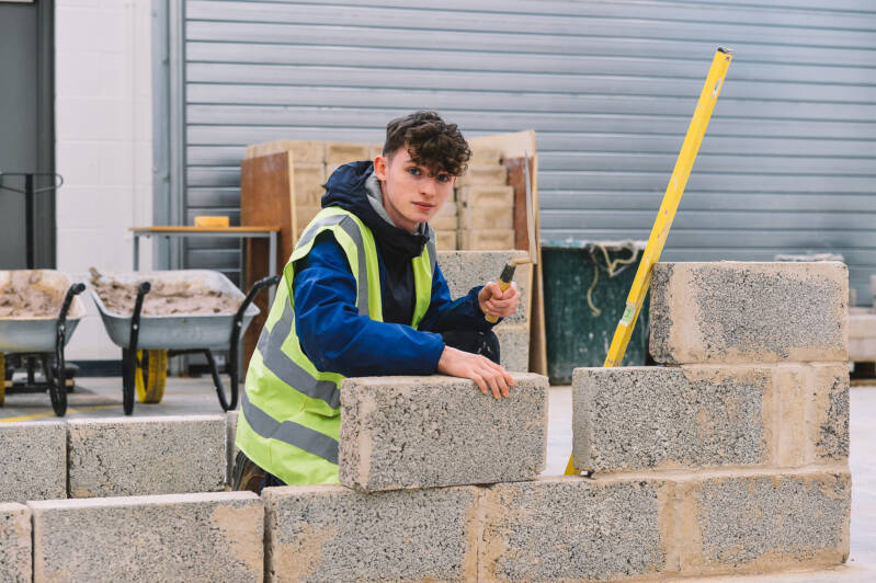 SRC apprenticeship student wearing a hi-vis vest and completing brickwork