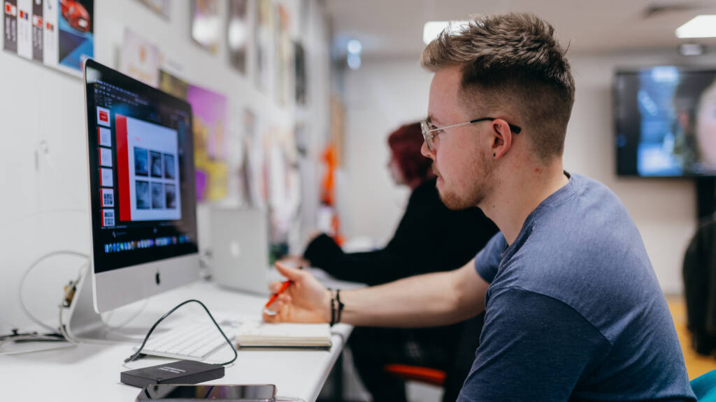 Student in a computer lab, using a desktop computer.