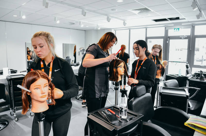 SRC students working on training heads in the SRC salon within Armagh Campus