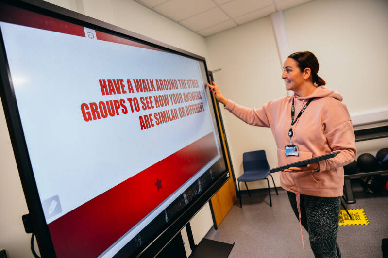 SRC staff member teaching using interactive whiteboard