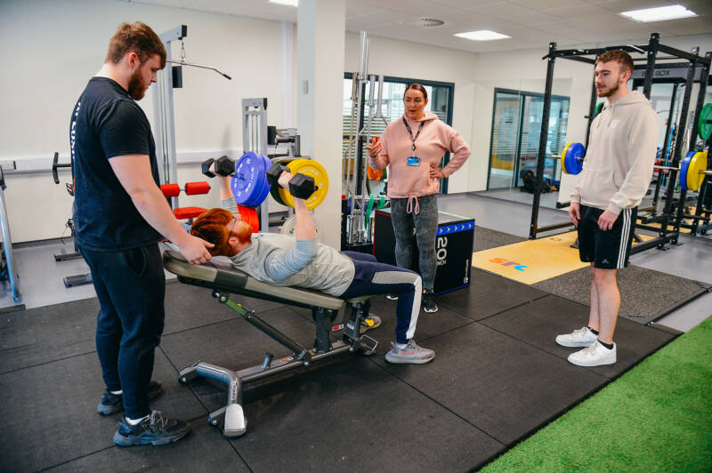 Group of students using fitness equipment in SRC Fitness Testing Lab as part of Sports Science course