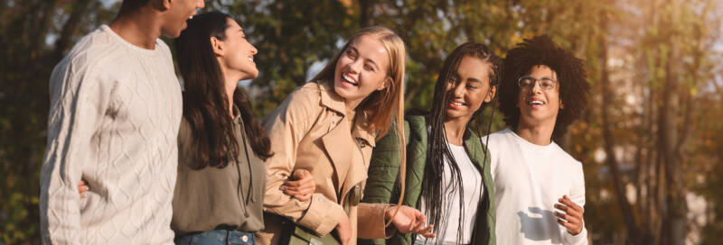 Happy students chatting while walking by park 2022 12 16 06 36 46 utc