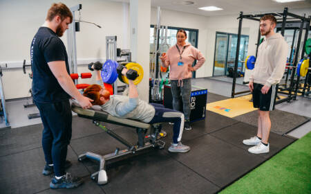 Group of students using fitness equipment in SRC Fitness Testing Lab as part of Sports Science course